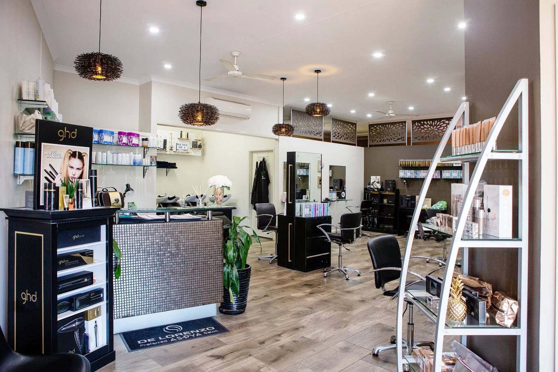 Inside Split Ends Hair Designs showing styling chairs, basins and ghd and De Lorenzo retail displays