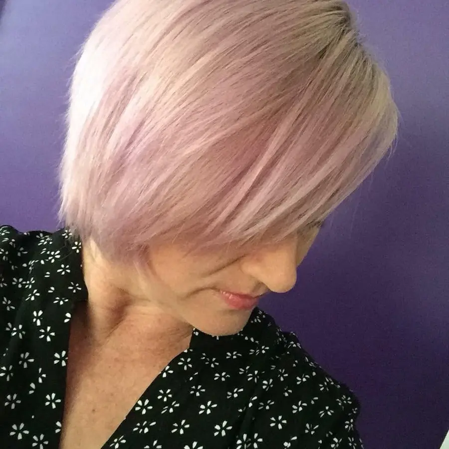 Short pale pink bob with a side-swept fringe