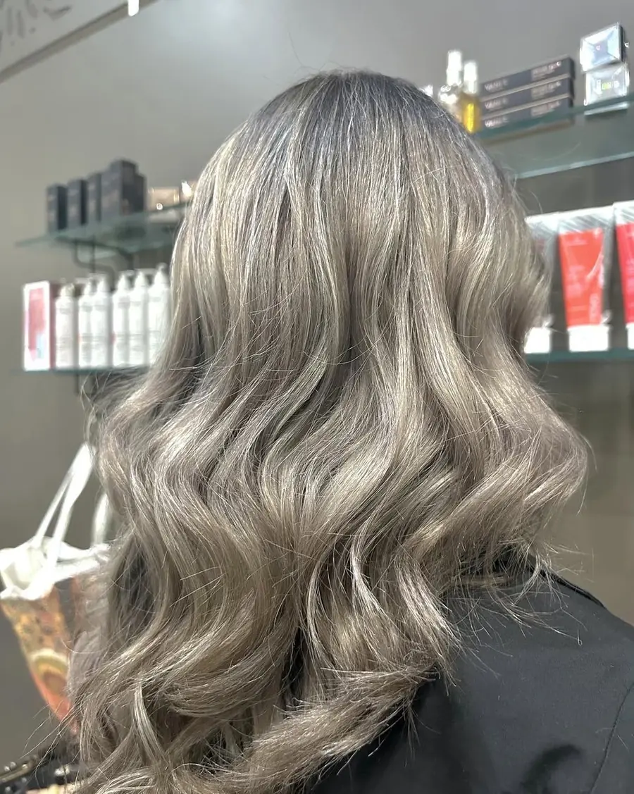 Long silver-grey hair styled in smooth waves