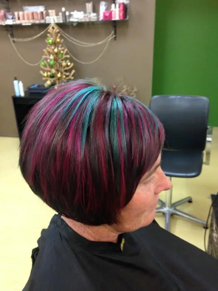 Short dark bob with vivid teal and magenta colour accents