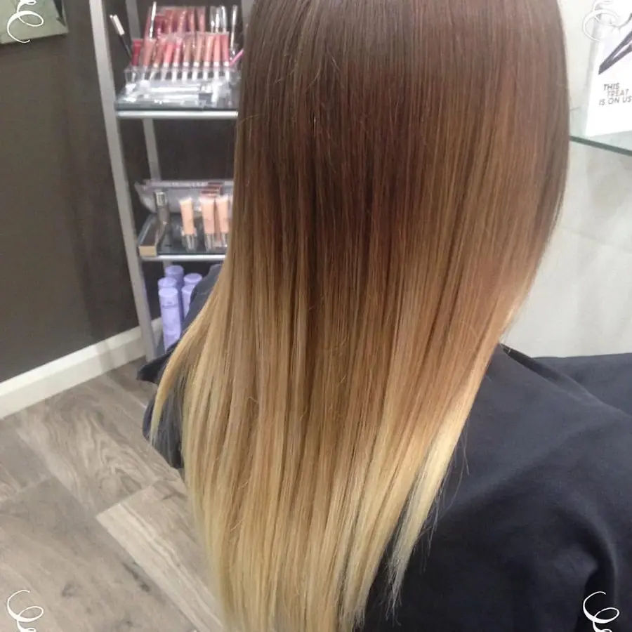 Long straight brunette hair fading to blonde through the lengths