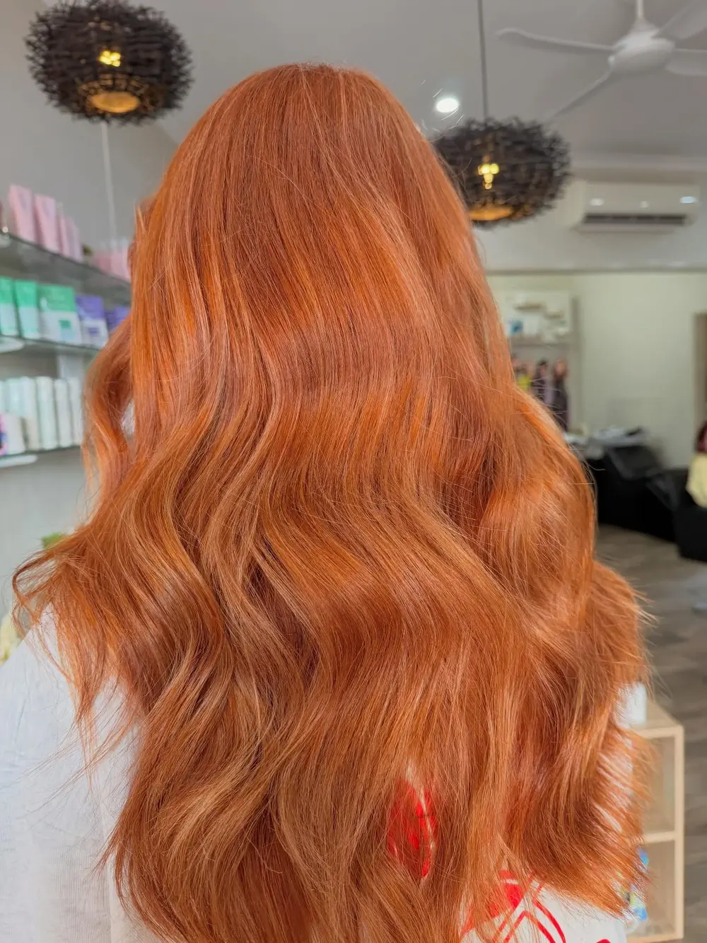 Long vivid copper hair styled in soft waves