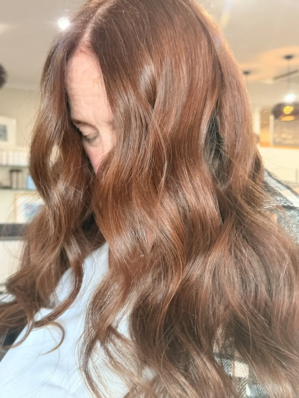 Long brunette hair finished in glossy loose waves