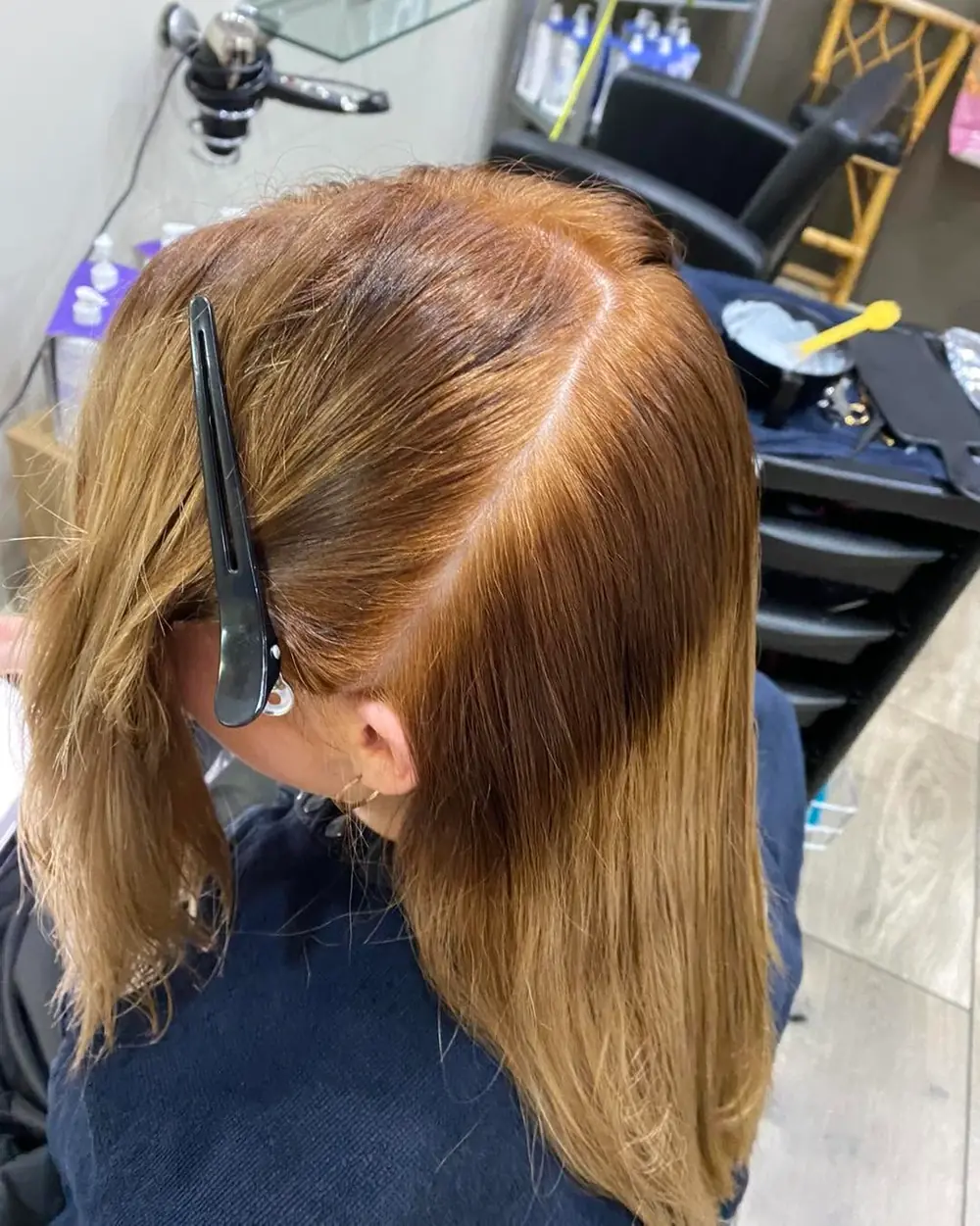 Hair sectioned with clips during a salon haircut
