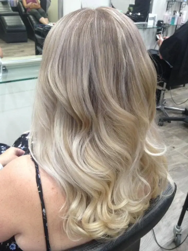 Blonde hair with cool-toned highlights and soft waves
