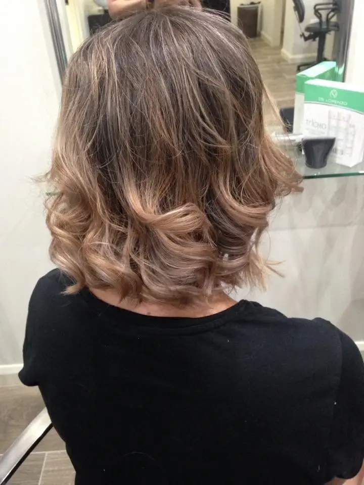 Short brown hair styled with curled ends and volume
